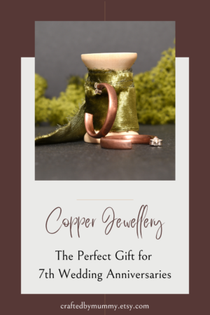 Copper Jewellelry: The Perfect Gift for 7th Wedding Anniversaries. Copper open hoop earrings displayed against a spool of green ribbon.
